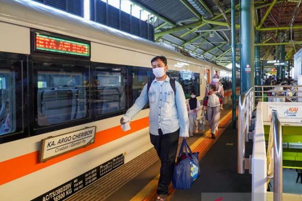 Ilustrasi pemudik kereta api melintas di samping kereta Argo Cheribon relasi Cirebon-Gambir di Stasiun Gambir Jakarta (foto:  ANTARA/PT KAI) 