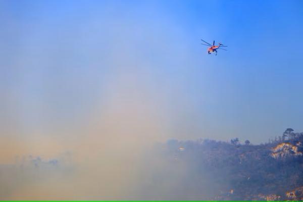 Helikopter pemadam kebakaran beroperasi, saat api berkobar di Gunung Parnitha, dekat Athena, Yunani, 29 Juni 2024. REUTERS 