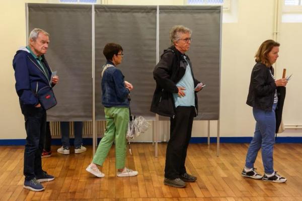 Orang-orang mengantri dalam pemilihan awal parlemen Prancis, di tempat pemungutan suara di Tulle, Prancis, 30 Juni 2024. REUTERS 