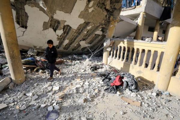 Seorang anak laki-laki Palestina berjalan di lokasi serangan Israel di sebuah sekolah yang menampung orang-orang terlantar, di Kota Gaza 27 November 2024. REUTERS 